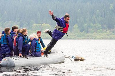 man-jumping-off-boat