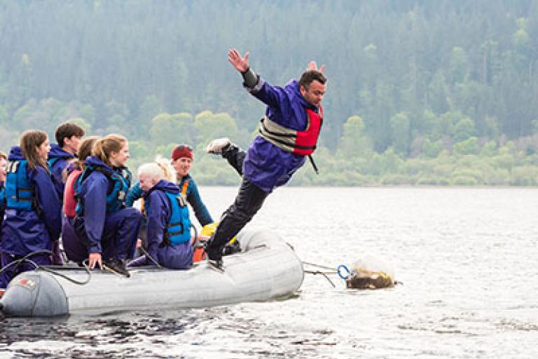 man-jumping-off-boat